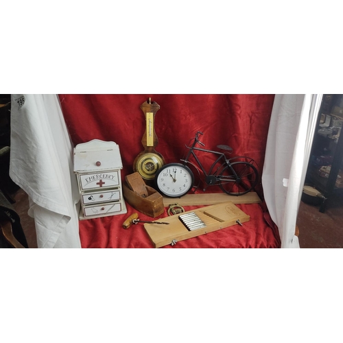 197 - An assortment of various items to include wood cased barometer, bicycle clock & more.