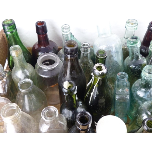 203 - A large collection of antique glass bottles.