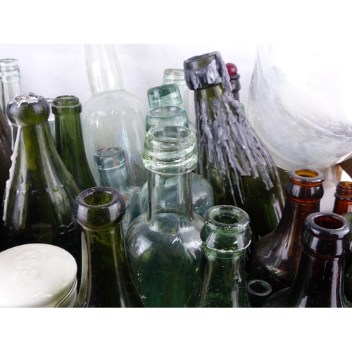 203 - A large collection of antique glass bottles.