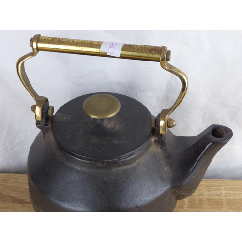 224 - An antique cast iron kettle.