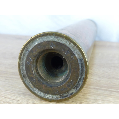 232 - A large antique brass shell casing, measuring 30cm tall.