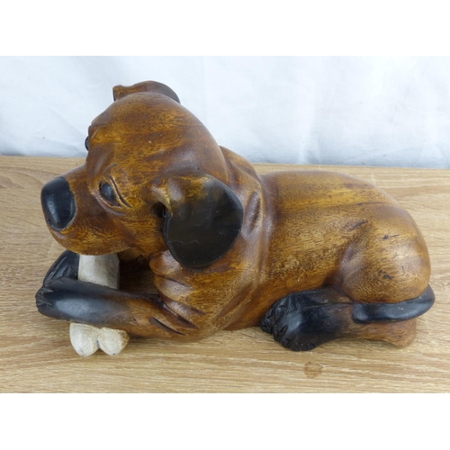 276 - A carved wooden dog figure.