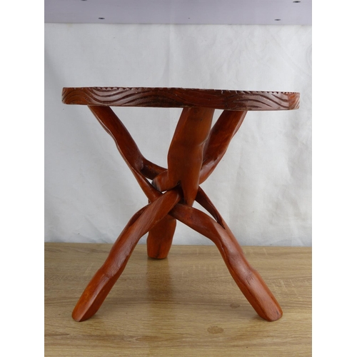 279 - A small hand carved wooden table on tripod base.