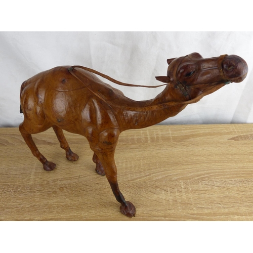 294 - A large handmade 'Liberty of London' style leather camel, measuring approx 34cm tall.