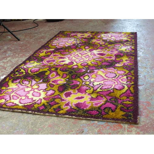 447 - A vintage patterned floor rug. 125cm x 70cm.