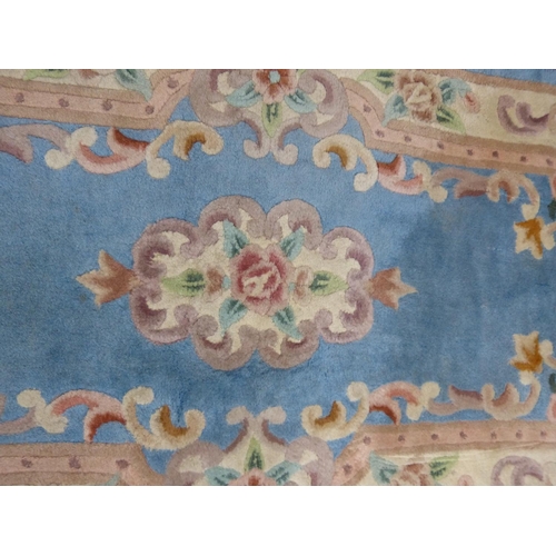 448 - A 'Lotus' blue patterned wool rug, measuring 5' x 2'6