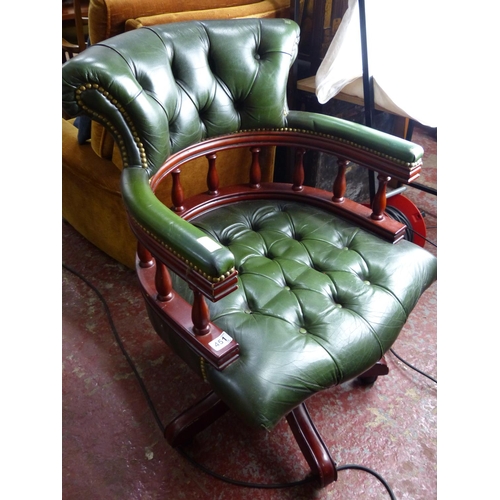 451 - A stunning leather upholstered captains style desk chair with swivel base.