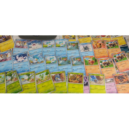 208 - A collection of Paldela Evolved Pokemon cards and a Pokemon Jiggly Puff cap with tags.