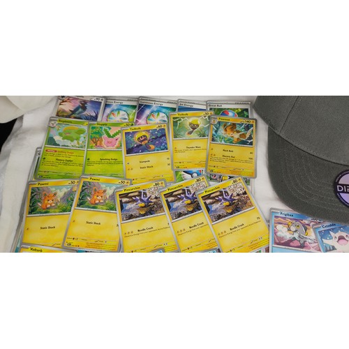 208 - A collection of Paldela Evolved Pokemon cards and a Pokemon Jiggly Puff cap with tags.