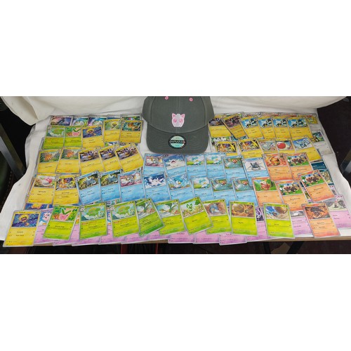 208 - A collection of Paldela Evolved Pokemon cards and a Pokemon Jiggly Puff cap with tags.