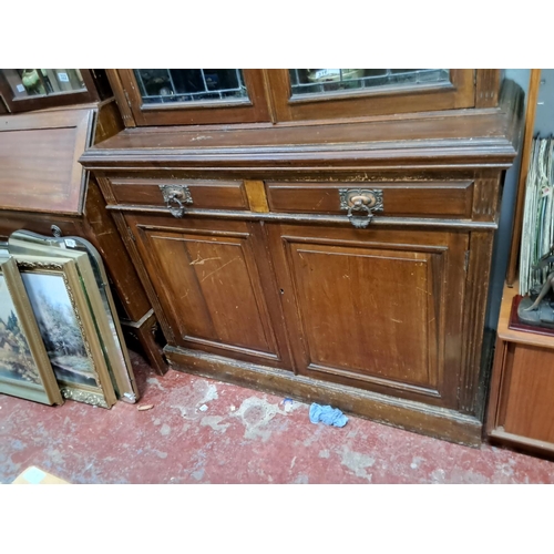 304 - An antique/ Edwardian library bookcase with stained glass and art nouveau copper fittings. (in need ... 