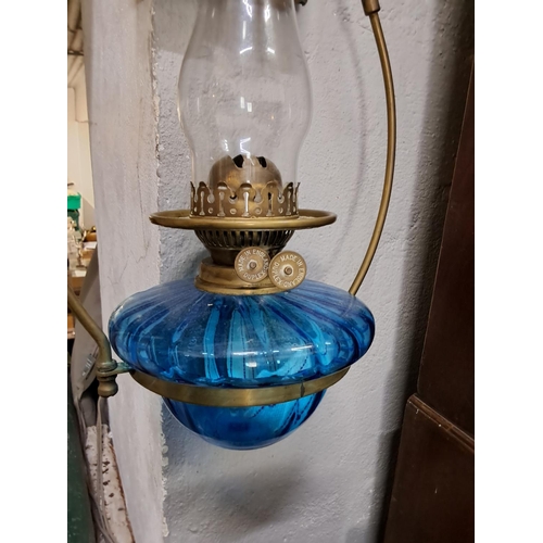 332 - An antique blue glass oil lamp with hanging bracket.