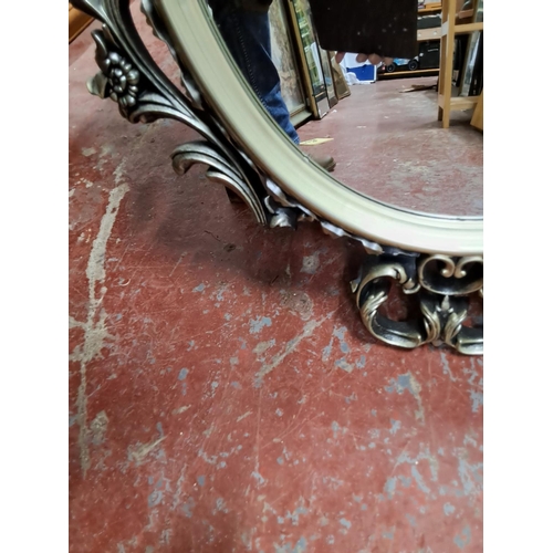 338 - An antique style mirror. Measuring 83cm x 57cm.