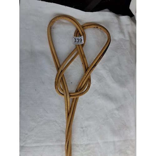 339 - A vintage rug beater.