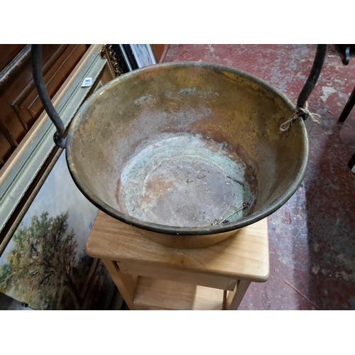 353 - A large antique brass preserve pot / jam pan.