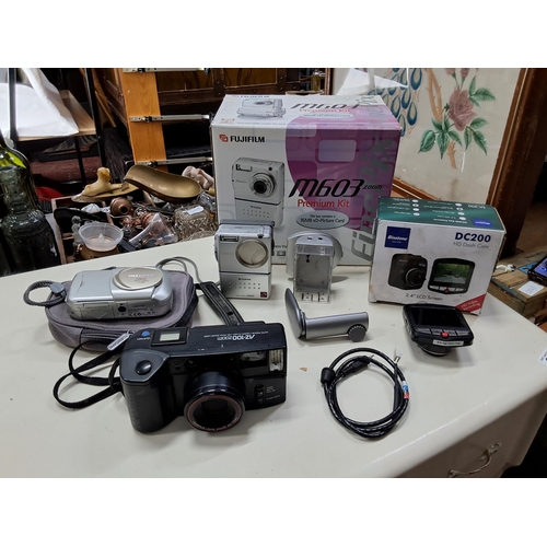 373 - An assortment of cameras to include a Olympus C-160 digital camera, a Fujifilm Finepix M603 and more... 