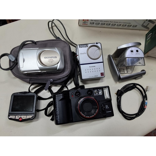 373 - An assortment of cameras to include a Olympus C-160 digital camera, a Fujifilm Finepix M603 and more... 