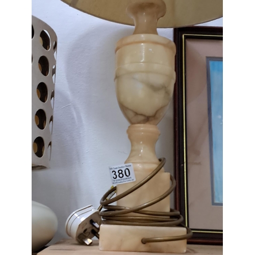 380 - A marble based table lamp with shade.