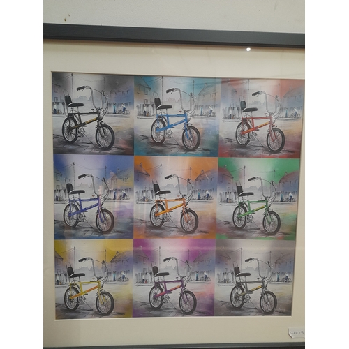 83 - A framed print of a chopper bike in various colours. Measuring 61cm x 61cm.