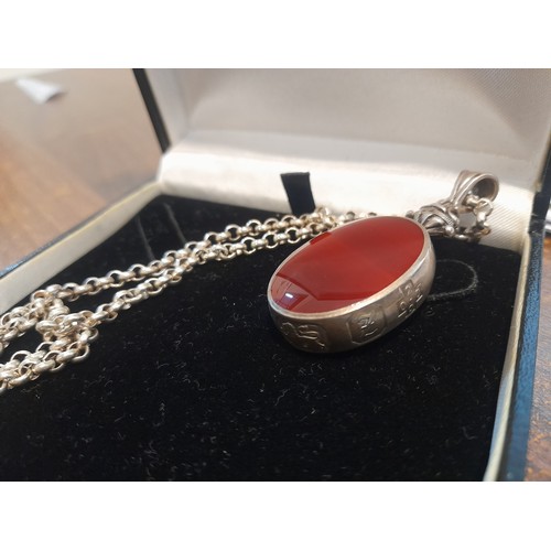 256 - Sterling Silver necklace with large double sided fob featuring an oval red and black gemstone with h... 