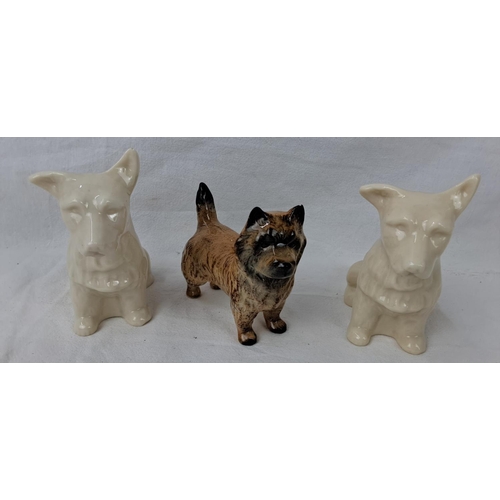 17 - Two green period Belleek dogs, along with a Beswick dog.