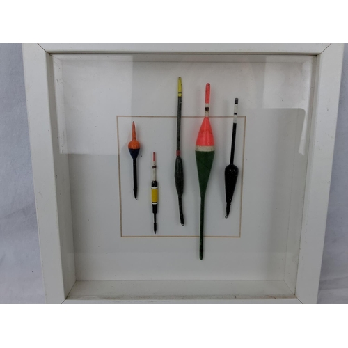 2 - A framed shadow box display of fishing floats.