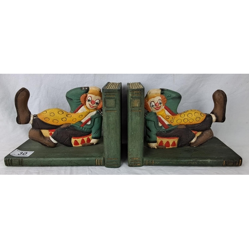 30 - A pair of wooden bookends in the form of clowns.