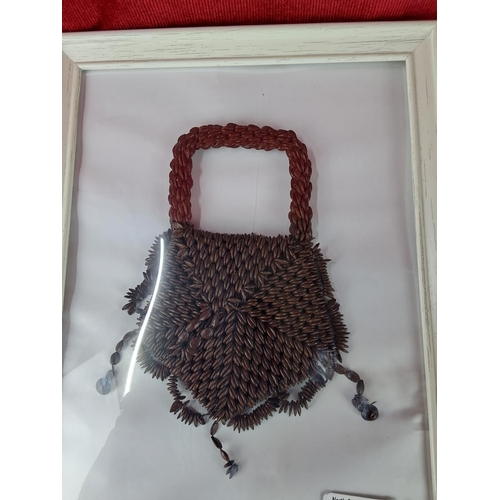 52 - An unusual apple seed purse in frame. Measuring 32cm x 23cm.