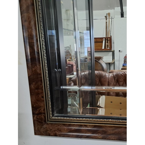 53 - A vintage wood framed mirror with bevelled glass. Measuring approx 83cm x 57cm.