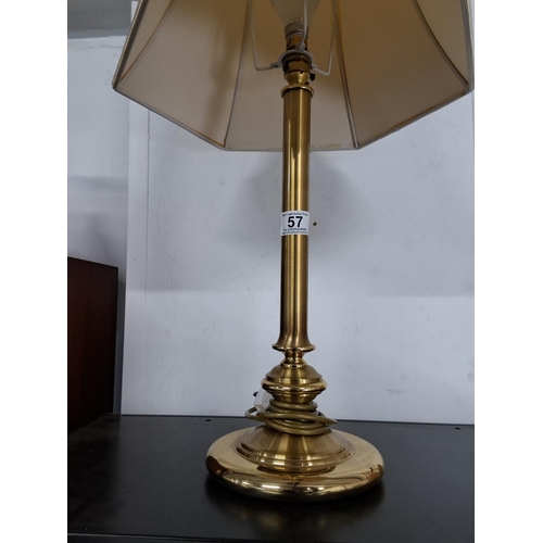 57 - A large brass table lamp and shade. Measuring 72cm Tall