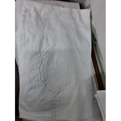 103 - A large assortment of vintage Irish linens including four Damask table cloths, large cover with lace... 