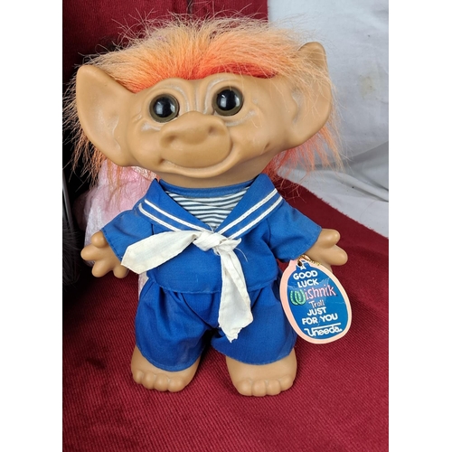 106 - An assortment of toys, to include a vintage troll doll.