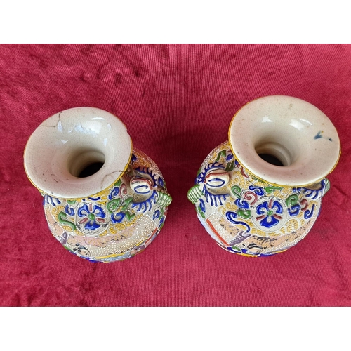 116 - A pair of Japanese style satsuma vases, each measuring 22cm tall.