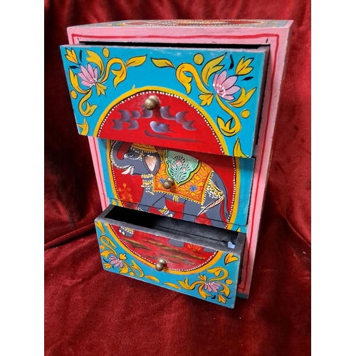 174 - A miniature chest of drawers with hand painted scenes. Measuring approx 29cm tall.