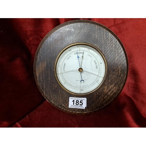 185 - An antique wood cased barometer, measuring 23cm wide.