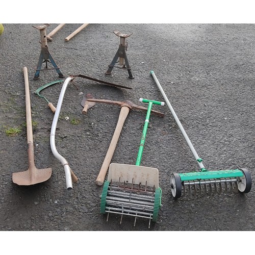 478 - An assortment of tools, to include a pickaxe, a shovel and more.