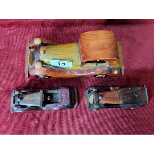 11 - Three vintage model wooden cars.