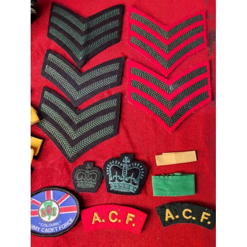 28 - A collection of military badges and patches.