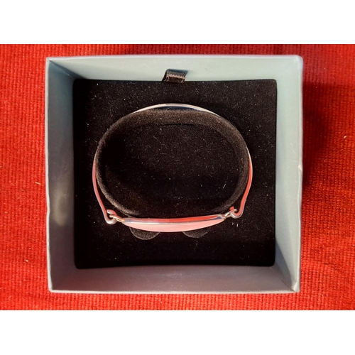 55 - A Sterling silver bangle.