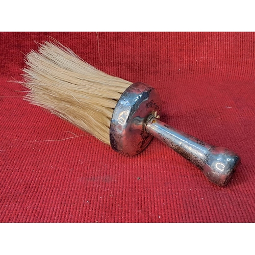 61 - An antique Sterling silver handled clothes brush. Measuring 14cm.