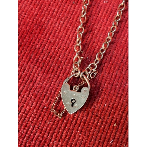 65 - A 9ct gold bracelet with padlock charm, weighing 6g