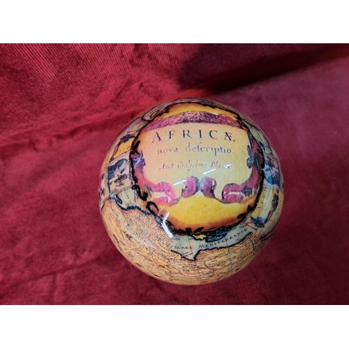 7 - An ostrich egg with African decoupage map design on wooden stand. Measuring 19cm tall.