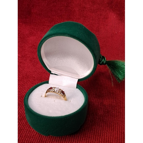 78 - A boxed 18ct gold ruby and opal ring, size L/M.