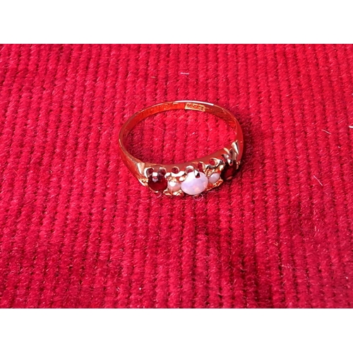 78 - A boxed 18ct gold ruby and opal ring, size L/M.