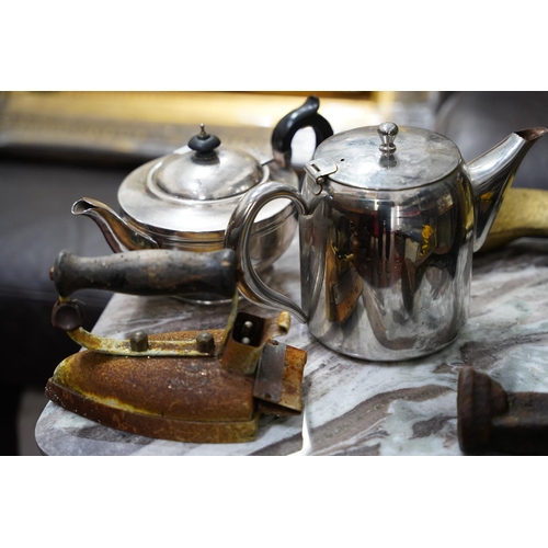 42 - Two antique cobbler shoe lasts, an iron and two teapots.