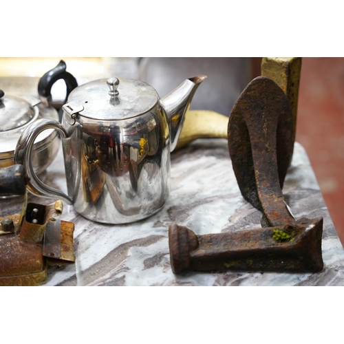 42 - Two antique cobbler shoe lasts, an iron and two teapots.