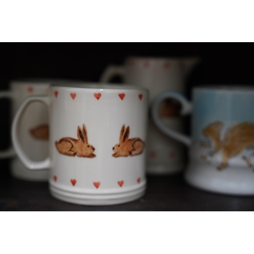 661 - Two mugs and jug hand painted with rabbits by Jane and Stephen Baughan, and two Christmas mugs Whitt... 