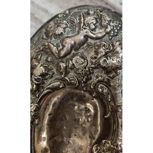 47 - An antique silver plated hand mirror. Measuring 26cm.