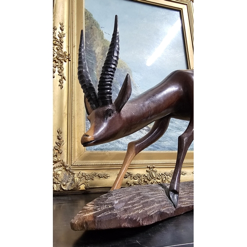 24 - A large vintage hand carved figure of an antelope, 15