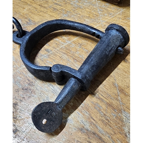 29 - A set of vintage/ antique handcuffs, no visible makers mark. Key & cuffs stamped '51'.